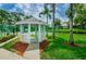 Charming gazebo in a well-maintained green space, surrounded by mature trees and lush grass at 2446 Bentley Dr, Palm Harbor, FL 34684