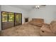 Cozy living room with tile flooring, fireplace, and access to a bright sunroom at 2446 Bentley Dr, Palm Harbor, FL 34684