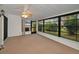 Enclosed porch with multiple windows, providing lots of natural light and view to the backyard at 2446 Bentley Dr, Palm Harbor, FL 34684