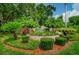 Beautiful entrance sign surrounded by lush landscaping at 2446 Bentley Dr, Palm Harbor, FL 34684