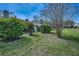 Well-maintained yard featuring manicured shrubs and lush green grass surrounding the property at 2446 Bentley Dr, Palm Harbor, FL 34684