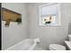 Bright bathroom featuring modern tiling, a built-in toiletry shelf, natural light, and contemporary fixtures at 2632 49Th S St, Gulfport, FL 33707