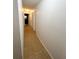 Hallway with neutral paint, tiled floor, and multiple doors at 2751 Cranberry S Blvd, North Port, FL 34286