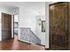 Upstairs hallway with wood floors, staircase with iron railings, and an elegant chandelier at 2810 W Wyoming Ave, Tampa, FL 33611