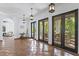 Bright living room featuring tile floors, pendant lighting and multiple french doors at 2810 W Wyoming Ave, Tampa, FL 33611