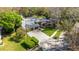 An aerial view of the home, showing its large lot, three-car garage, and well-kept landscaping at 3137 Valemoor Dr, Palm Harbor, FL 34685