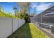 The backyard features a screened-in pool area, with a view of the home's fence-lined perimeter at 3137 Valemoor Dr, Palm Harbor, FL 34685