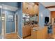 Well-stocked bar area featuring mirrored shelving, a sink, wood paneling, and backyard access at 3137 Valemoor Dr, Palm Harbor, FL 34685