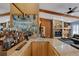 Luxurious bar area featuring beautiful countertop, storage, and mirrored shelving with an array of spirits at 3137 Valemoor Dr, Palm Harbor, FL 34685