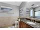 This bathroom showcases a granite countertop, an undermount sink, and an arched window over the bathtub at 3137 Valemoor Dr, Palm Harbor, FL 34685
