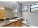 Bathroom featuring a granite countertop, a mirror, and a shower with tile at 3137 Valemoor Dr, Palm Harbor, FL 34685