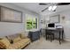 Bright bedroom with an office desk, comfortable sofa, and windows for natural light at 3137 Valemoor Dr, Palm Harbor, FL 34685