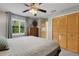 This cozy bedroom offers a ceiling fan, dresser, and night stands at 3137 Valemoor Dr, Palm Harbor, FL 34685