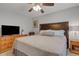 This cozy bedroom offers a ceiling fan, TV, dresser and night stands at 3137 Valemoor Dr, Palm Harbor, FL 34685