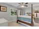 This cozy bedroom offers a ceiling fan, dresser, and night stands at 3137 Valemoor Dr, Palm Harbor, FL 34685