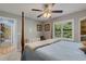 Comfortable bedroom with a four-poster bed and ceiling fan for a relaxed and airy atmosphere at 3137 Valemoor Dr, Palm Harbor, FL 34685