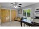 Well-lit bedroom with windows, wooden closet, ceiling fan, and carpet at 3137 Valemoor Dr, Palm Harbor, FL 34685