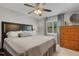 This cozy bedroom offers a ceiling fan, dresser, and night stands at 3137 Valemoor Dr, Palm Harbor, FL 34685