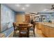 Comfortable kitchen and dining area featuring a round wood table, eat-in kitchen, and fireplace in the living room at 3137 Valemoor Dr, Palm Harbor, FL 34685