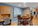 Comfortable dining space with round table, study desk, built-in storage, and large abstract art piece at 3137 Valemoor Dr, Palm Harbor, FL 34685