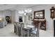 Open-concept dining room with elegant lighting fixtures and access to the living room and study at 3137 Valemoor Dr, Palm Harbor, FL 34685