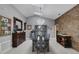 Elegant dining room with stylish lighting, stone accent wall and ample seating for entertaining at 3137 Valemoor Dr, Palm Harbor, FL 34685