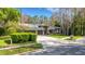 The exterior showcases an expansive driveway and well-manicured landscaping, enhancing curb appeal at 3137 Valemoor Dr, Palm Harbor, FL 34685