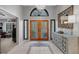Bright foyer with tile flooring and a decorative mirror at 3137 Valemoor Dr, Palm Harbor, FL 34685