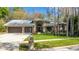Charming single-story home with a three-car garage, manicured lawn, and beautiful landscaping at 3137 Valemoor Dr, Palm Harbor, FL 34685