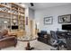 This home office features custom built-in shelving, a vintage oval table, and a comfortable desk space at 3137 Valemoor Dr, Palm Harbor, FL 34685