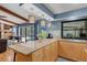 Kitchen features a breakfast bar with seating that overlooks the living area and a beautiful outdoor pool at 3137 Valemoor Dr, Palm Harbor, FL 34685