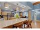Open concept kitchen with breakfast bar, stainless steel appliances and pendant lighting overlooking the dining area at 3137 Valemoor Dr, Palm Harbor, FL 34685