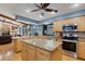 Open kitchen design featuring light wood cabinetry, granite countertops, and stainless-steel appliances at 3137 Valemoor Dr, Palm Harbor, FL 34685