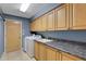 Functional laundry room equipped with ample storage, a utility sink, and modern washer and dryer at 3137 Valemoor Dr, Palm Harbor, FL 34685