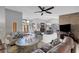 Open living room flowing into dining area features stone accent wall, ceiling fan, and neutral tile floor at 3137 Valemoor Dr, Palm Harbor, FL 34685