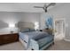 Spacious main bedroom features neutral decor, complemented by a modern ceiling fan and ensuite bathroom access at 3137 Valemoor Dr, Palm Harbor, FL 34685