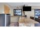 Granite-topped outdoor bar area with a mini-fridge, seating, and a window to the interior, creating an ideal entertainment space at 3137 Valemoor Dr, Palm Harbor, FL 34685