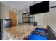 Outdoor bar area features granite countertop, seating, mini-fridge, and a view of the pool area from the adjacent window at 3137 Valemoor Dr, Palm Harbor, FL 34685