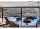 Patio dining area offering a view of the screened-in pool and outdoor furniture, perfect for entertaining and relaxation at 3137 Valemoor Dr, Palm Harbor, FL 34685
