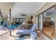 Covered patio features stylish lounge furniture, dining set, ceiling fan, and seamless indoor-outdoor flow with sliding glass doors at 3137 Valemoor Dr, Palm Harbor, FL 34685