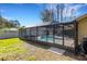 A screened-in pool sits in the home's backyard, providing a private outdoor retreat at 3137 Valemoor Dr, Palm Harbor, FL 34685