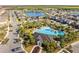 Aerial view of the community pool, playground, and surrounding residences, showcasing community amenities and neighborhood layout at 3148 Marine Grass Dr, Wimauma, FL 33598