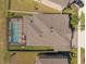 High angle view of a house roof and screened-in swimming pool in a fenced backyard at 3148 Marine Grass Dr, Wimauma, FL 33598