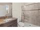 Bathroom featuring a modern shower with glass doors, granite countertops, and updated fixtures at 3148 Marine Grass Dr, Wimauma, FL 33598