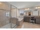 Bathroom with a large vanity, a separate desk area, soaking tub, and walk-in shower at 3148 Marine Grass Dr, Wimauma, FL 33598