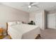 Bedroom features neutral colors and desk near a double doorway at 3148 Marine Grass Dr, Wimauma, FL 33598