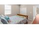 Serene bedroom with a queen-sized bed, closet, and a view of the backyard pool at 3148 Marine Grass Dr, Wimauma, FL 33598