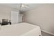 Bedroom featuring a bed, desk, and view into the hallway at 3148 Marine Grass Dr, Wimauma, FL 33598