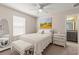 A cozy bedroom showcasing a comfortable bed, soft lighting, and an en-suite bathroom for added privacy at 3148 Marine Grass Dr, Wimauma, FL 33598