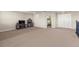 Large bonus room offering adaptable space with neutral carpeting, TV, and convenient access to adjacent rooms at 3148 Marine Grass Dr, Wimauma, FL 33598